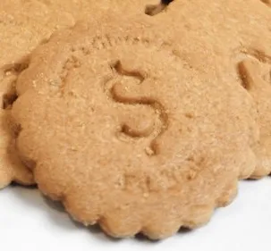 Image of a biscuit style cookie with serated edge. There is a depression the shape of a dollar symbol in the center.